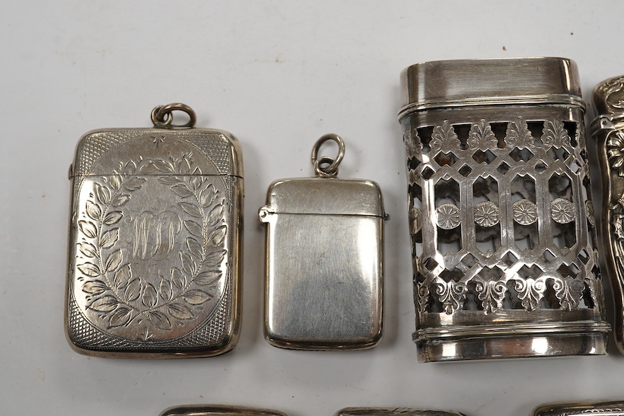 Seven assorted late 19th/early 20th century silver vesta cases, largest 48mm, a sterling case and one other pierced white metal case. Condition - poor to fair